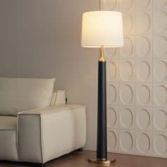 Stylish modern floor lamp with beige shade and black-gold finish, ideal for enhancing interior decor in living rooms or optical clinics.