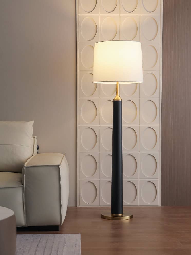 Elegant modern floor lamp with a white shade and black gold base, ideal for living room décor, enhancing comfort and style. Perfect for creating a warm ambiance in your home or clinic.