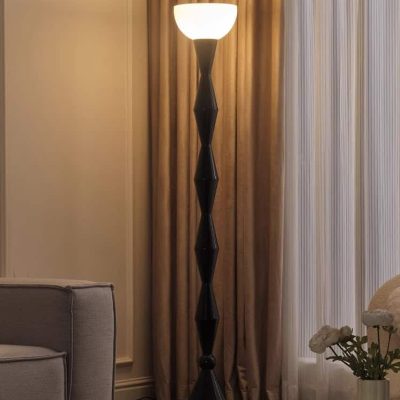 Floor lamp with modern geometric black base and white lampshade in stylish living room, cozy interior decor, perfect for contemporary home lighting.