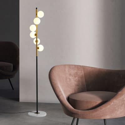 Floor lamp with modern design, spherical white bulbs, and black and gold accents, ideal for stylish home lighting.