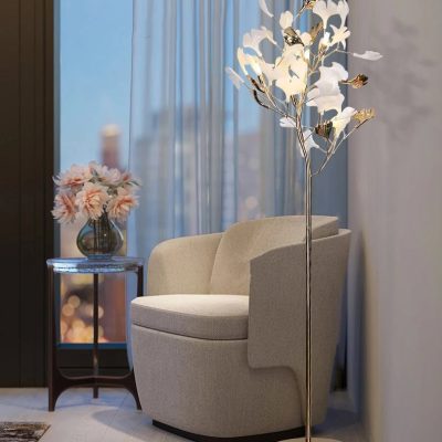 Elegant beige armchair with decorative lamps and flowers in a modern, stylish interior setting at Monalisa Store for optical and eyewear shopping.