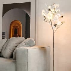 Relaxing modern interior image with a cozy beige couch, decorative cushions, stylish floral floor lamp, and colorful arched wall art, creating a luxurious and inviting ambiance for medispa or aesthetic clinic.