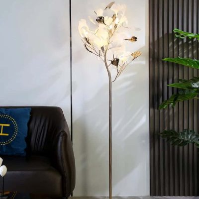 Modern gold flower LED floor lamp with marble base in stylish home decor setting.