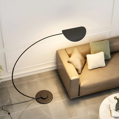Modern black arc floor lamp in stylish living room with beige sofa and decorative pillows, perfect for contemporary interior decor.
