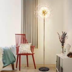 Elegant modern bedroom corner with fashionable red armchair, stylish floor lamp, cozy throw pillow, and minimalist decor creating a comfortable and inviting ambiance.