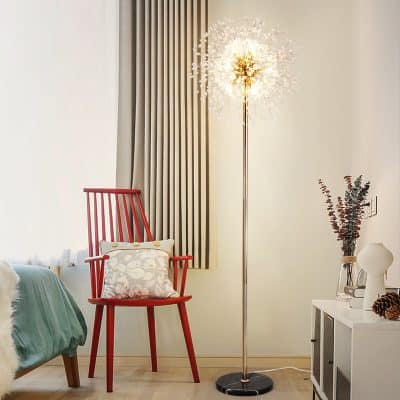 Elegant modern bedroom corner with fashionable red armchair, stylish floor lamp, cozy throw pillow, and minimalist decor creating a comfortable and inviting ambiance.