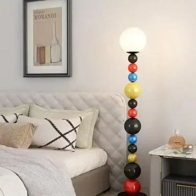 Colorful modern floor lamp with various ball-shaped segments in a stylish bedroom setting.