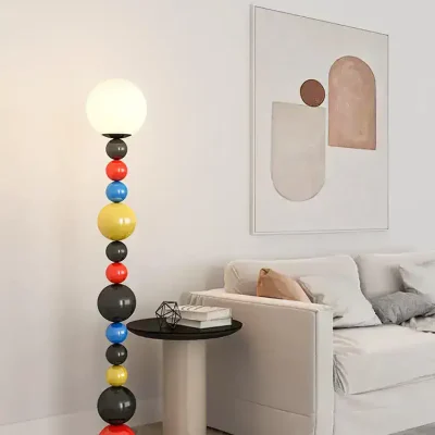 Colorful modern floor lamp with spherical design and soft white light in stylish living room setting.
