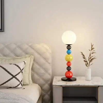 Colorful modern table lamp with spherical base design on bedroom nightstand in Monalisa Medical store aesthetic.