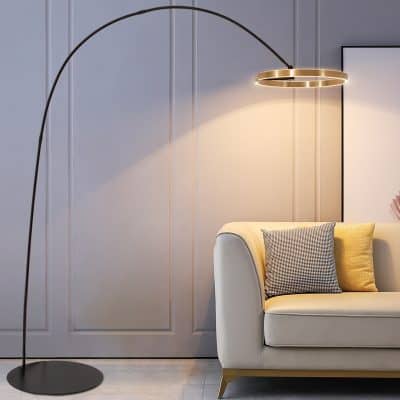 Elegant modern floor lamp with a gold accent and arched design in stylish interior decor, ideal for living rooms or offices.