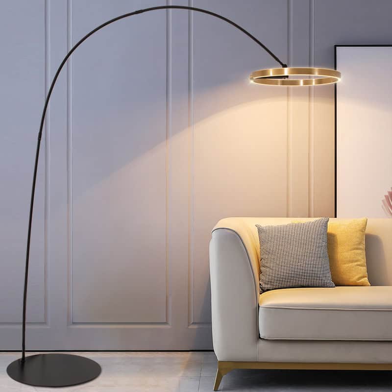 Elegant modern floor lamp with a gold accent and arched design in stylish interior decor, ideal for living rooms or offices.