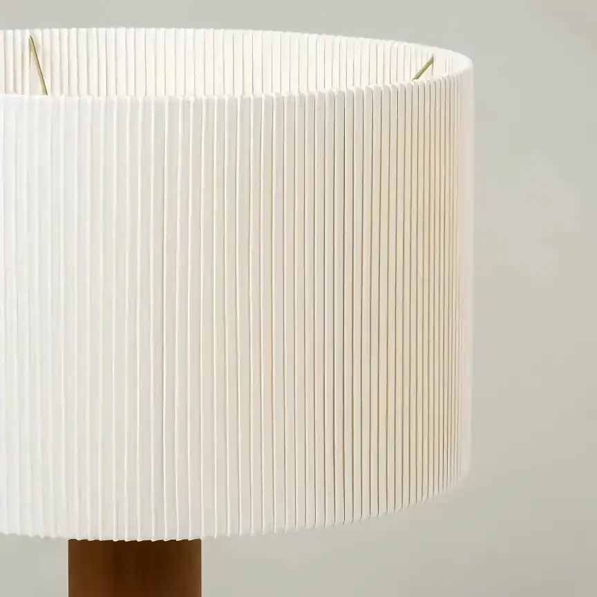 White modern table lamp with pleated fabric shade for stylish interior decor.