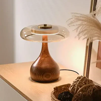 Elegant wooden and glass table lamp with a modern design, creating a warm ambiance in a stylish interior space. Perfect for enhancing a cozy, contemporary home or office decor.