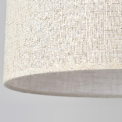 Soft beige fabric lampshade close-up, modern home lighting decor, high-quality linen material for stylish interior design.
