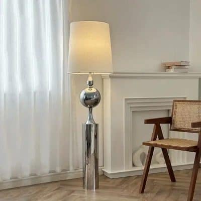 Elegant modern floor lamp with a chrome finish and a soft white lampshade, perfect for adding stylish lighting to your home or office decor.