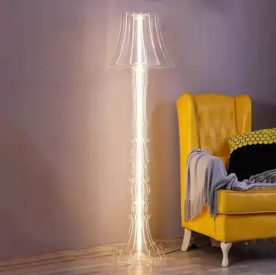 Elegant yellow armchair with a gray throw blanket and black and yellow pillow, next to a modern floor lamp with a unique glowing design, in a contemporary living space for stylish interior decor.