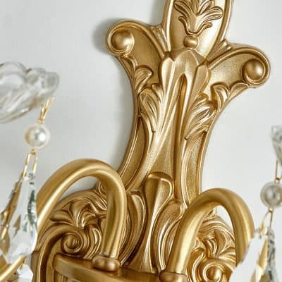 Ornate gold wall sconce with intricate baroque design, perfect for luxury home or boutique hotel decor.