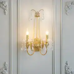Elegant gold and crystal wall sconce with dual candle-style lights, perfect for luxury interior decor, hotel, or bedroom lighting.