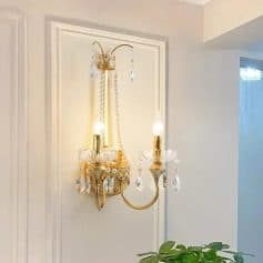 Elegant gold wall sconce with crystal accents for luxurious lighting decor.