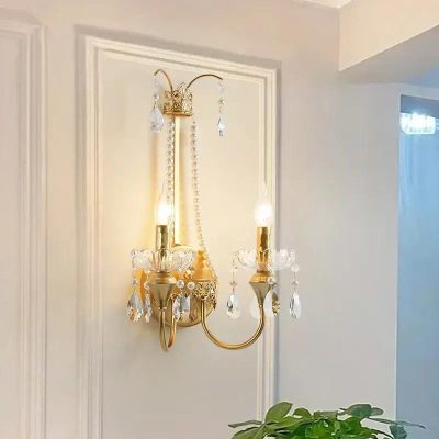 Elegant gold wall sconce with crystal accents for luxurious lighting decor.
