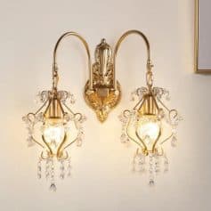 Elegant gold and crystal wall sconce chandelier lighting fixture with ornate design, suitable for enhancing interior decor, luxury, and aesthetic ambiance in homes or hotels.