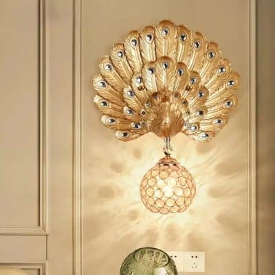 Peacock-inspired gold wall sconce with peacock feather design, ornate lighting fixture enhancing luxury interior decor.