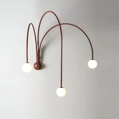 Modern stylish wall light fixture with three spherical bulbs and curved metal arms, ideal for interior lighting in homes or medical clinics, enhancing aesthetic appeal.
