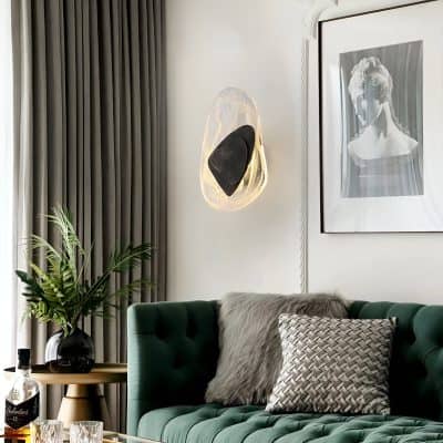 Luxurious living room interior with elegant green velvet sofa, stylish wall art, modern lighting fixture, and decorative cushions, perfect for a contemporary home decor setting.