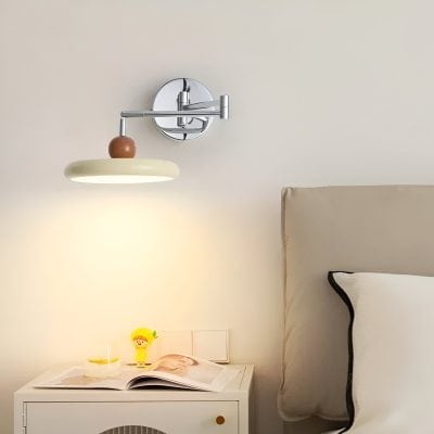 Modern bedside wall lamp with adjustable arm, sleek chrome finish, and minimalist design for bedroom decor.