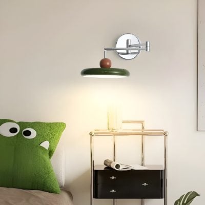Contemporary wall-mounted adjustable reading lamp above a modern side table in a stylish bedroom setting.