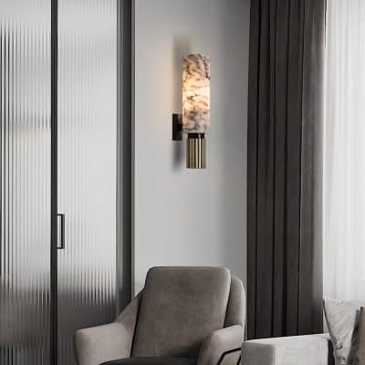 Elegant minimalist interior with a modern wall sconce, plush beige and gray chairs, and sleek design elements, ideal for optometry and eyewear retail at Monalisa Store.