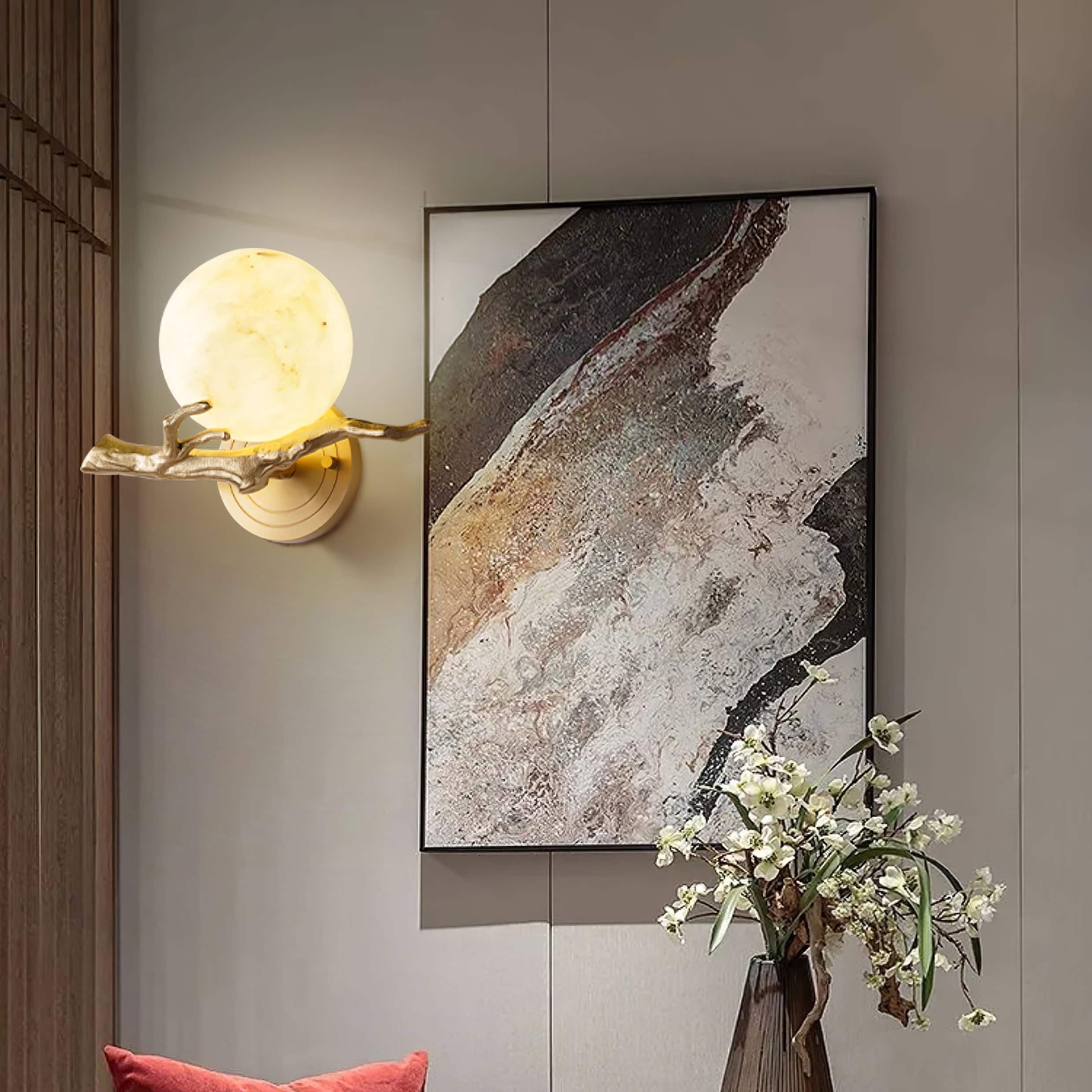 Elegant modern interior décor with contemporary wall art, unique lighting fixture, and a stylish flower arrangement, perfect for an optometry or eyewear store ambiance.