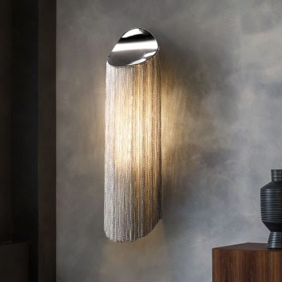 Elegant modern wall sconce with metallic chains and ambient lighting for luxury home decor and interior design.