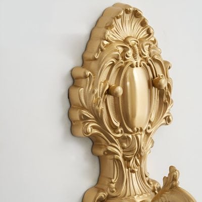 Luxurious gold decorative wall sconce with intricate ornate design, ideal for high-end interior decor and upscale office or home lighting.