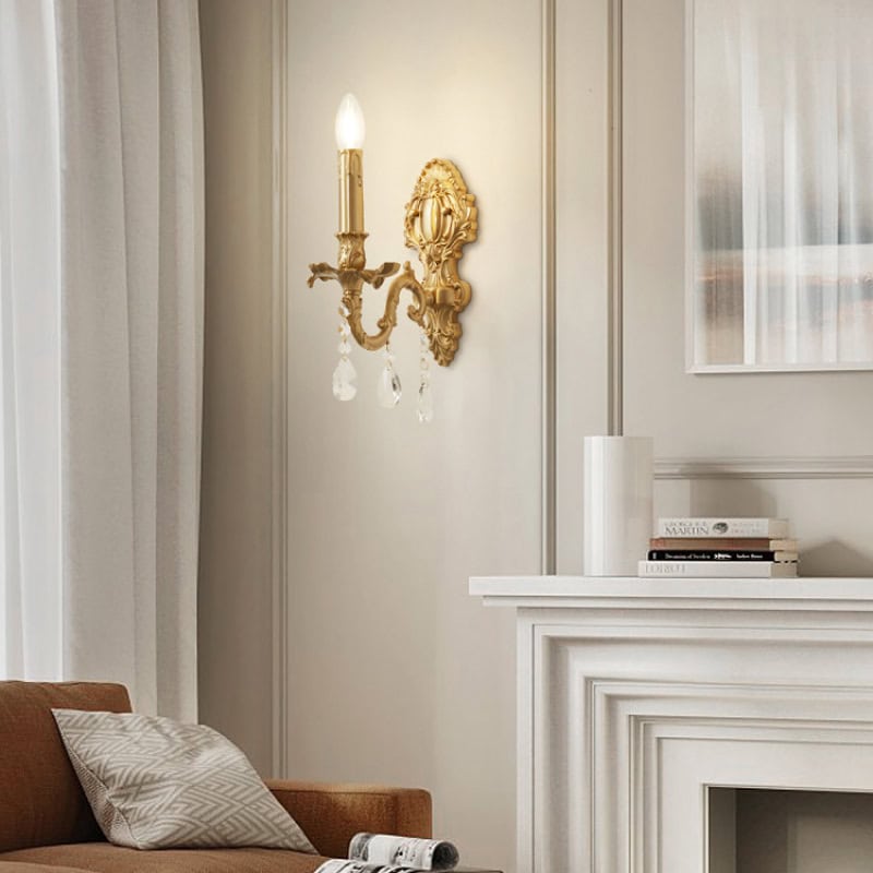 Elegant gold wall sconce with crystal embellishments illuminating a sophisticated living room decor.