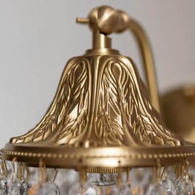 Golden chandelier with intricate leaf design and crystal accents, adding elegance to any space. Ideal for enhancing interior decor with a luxurious touch. Perfect for living rooms, dining areas, or entryways.