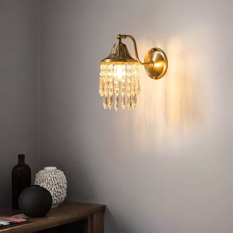 Elegant gold and crystal wall sconce lighting fixture for stylish home decor and interior design illumination.