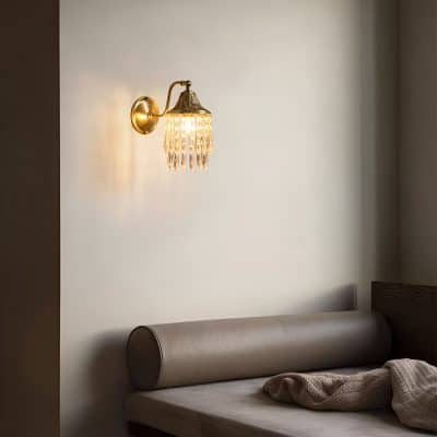 Elegant wall sconce with crystal accents providing ambient lighting in a minimalist bedroom setting. Perfect for enhancing comfort and style in eyewear and optometry clinics.