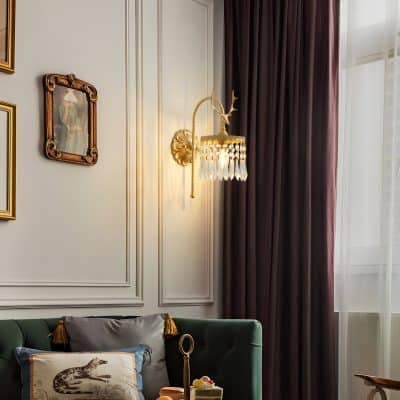 Elegant wall-mounted chandelier with crystal accents in a luxurious living room setting.