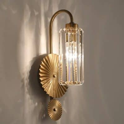 Elegant gold and crystal wall sconce lighting fixture, perfect for modern interior decor, enhances ambiance and style in residential or commercial spaces.
