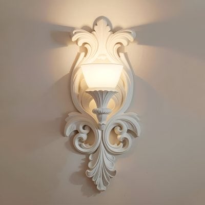 Elegant ornate white wall sconce with decorative carvings, perfect for luxurious interior lighting. Ideal for enhancing sophisticated spaces with classic and stylish ambiance.