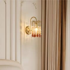 Elegant gold wall sconce with crystal accents for sophisticated interior decor.