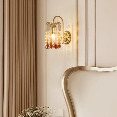 Elegant boutique hotel bedroom with a luxurious wall sconce illuminating the soft beige wall and classic decor.