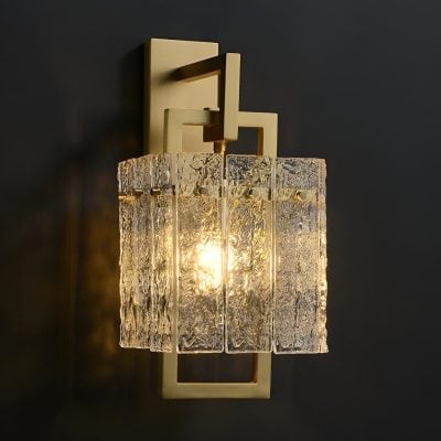 Elegant modern wall sconce featuring textured glass and a geometric metal frame, perfect for enhancing aesthetic appeal in medical or luxury interior spaces.