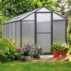 Durable greenhouse with aluminum frame and polycarbonate panels, perfect for gardening and plant protection.