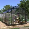Beautiful greenhouse with glass panels and black metal frame, ideal for gardening and plant cultivation, perfect for backyard or garden use.