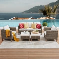 Stylish outdoor lounge with wicker furniture, cozy cushions, and a view of the ocean and mountains, perfect for relaxing on the Monalisa Store patio.