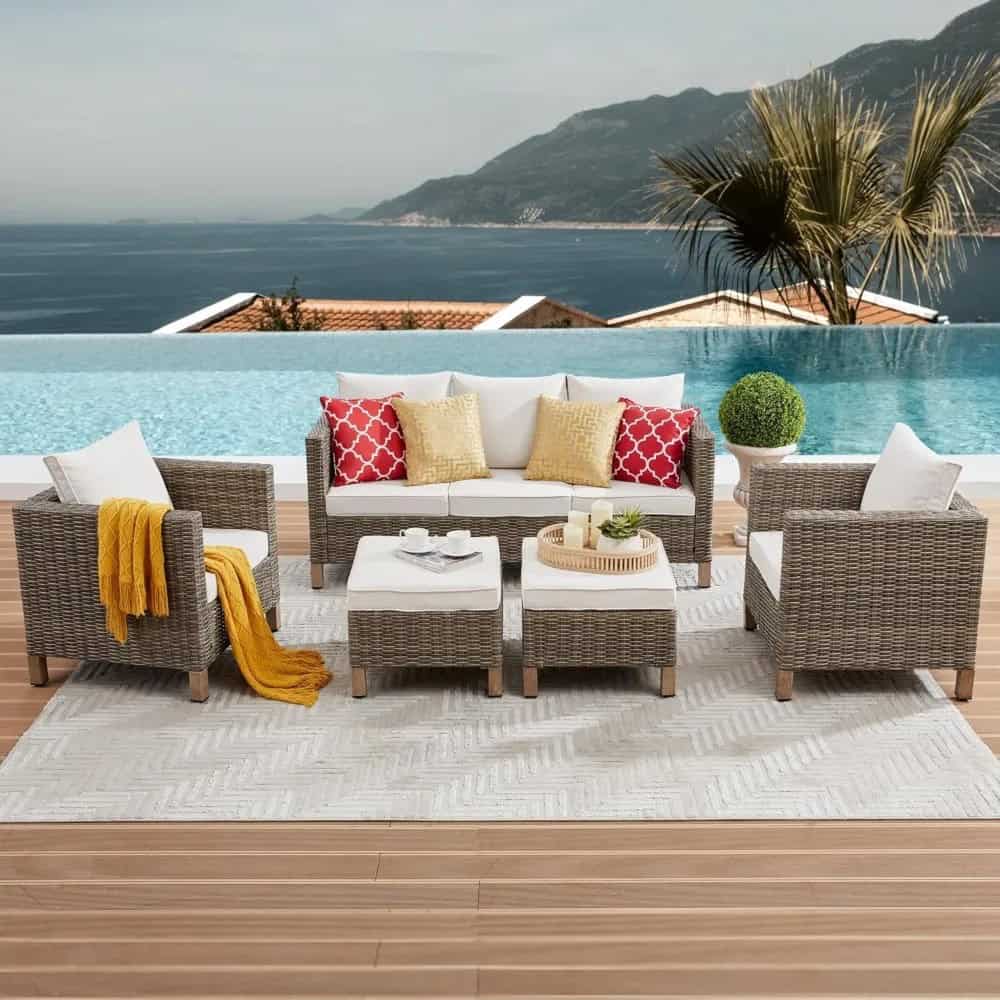 Stylish outdoor lounge with wicker furniture, cozy cushions, and a view of the ocean and mountains, perfect for relaxing on the Monalisa Store patio.