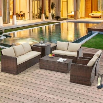 Modern patio outdoor furniture set with rattan couches and coffee table near swimming pool at luxury villa.
