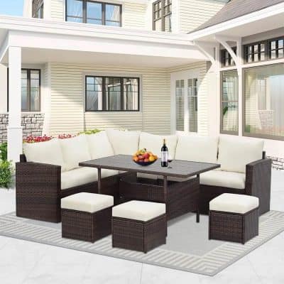 Outdoor patio furniture set featuring a corner sofa, stools, and a table with a fruit bowl and wine bottle, designed for stylish outdoor living and relaxation.